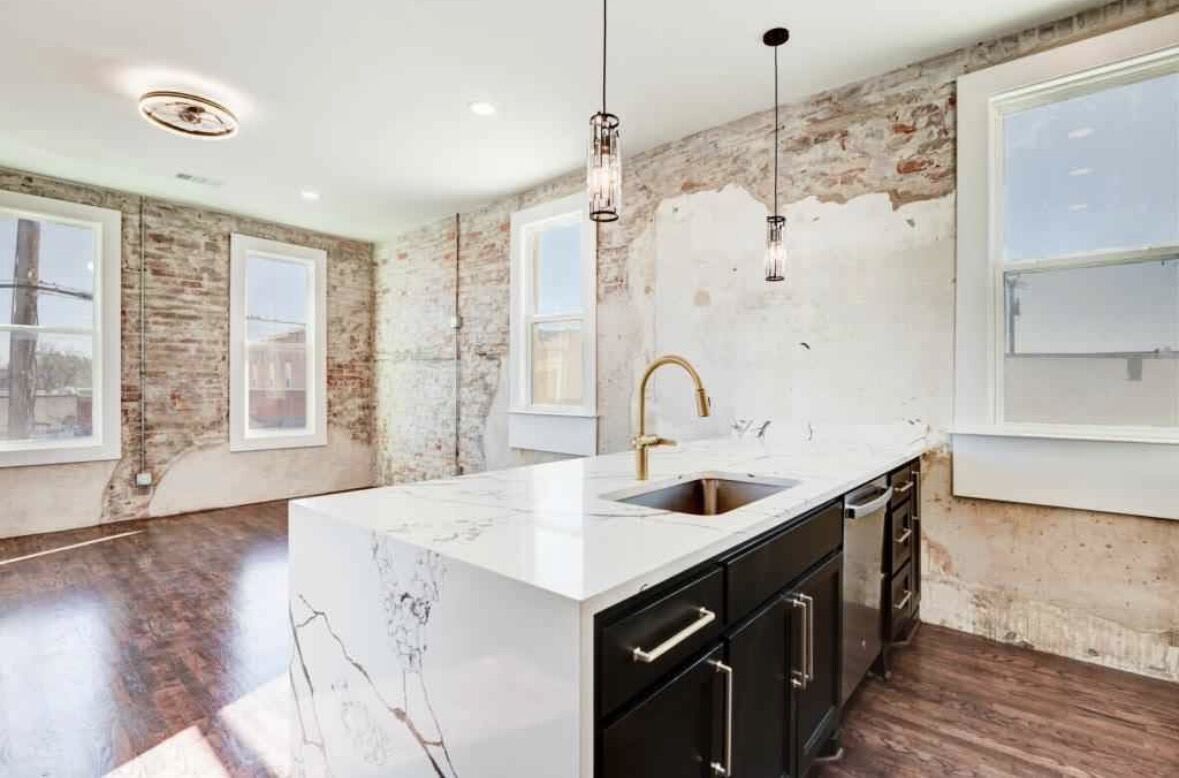 Loft kitchen island with marble waterfall countertop