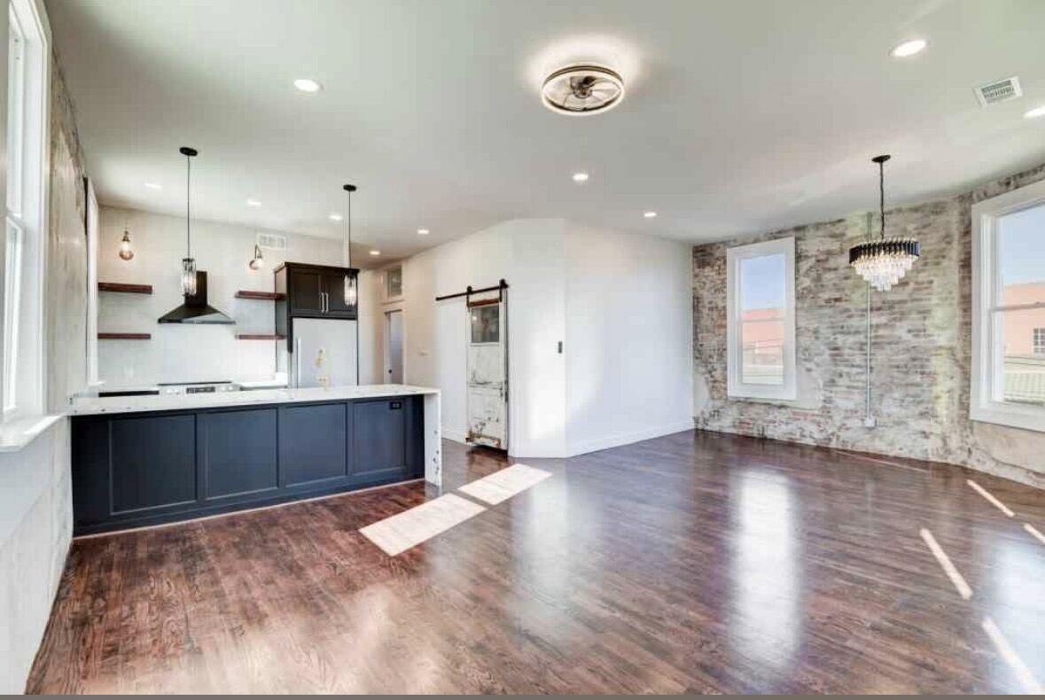 Open loft with exposed brick walls, mid-renovation
